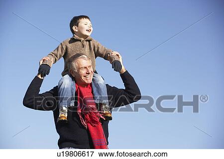 Stock Photo - Grandfather Carrying Grandson On His Shoulders. Fotosearch