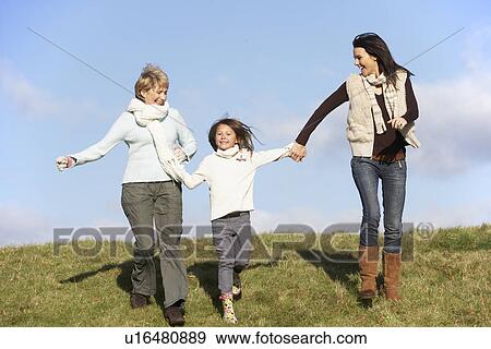 Grandmother And Mother Holding Hands With Young Girl View Large Photo Image Stock Photo - Grandmother And Mother Holding Hands With Young Girl. Fotosearch