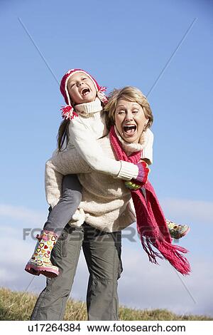 Grandmother Giving Her Granddaughter A Piggy Back Ride View Large Photo Image Picture - Grandmother Giving Her Granddaughter A Piggy Back Ride. Fotosearch