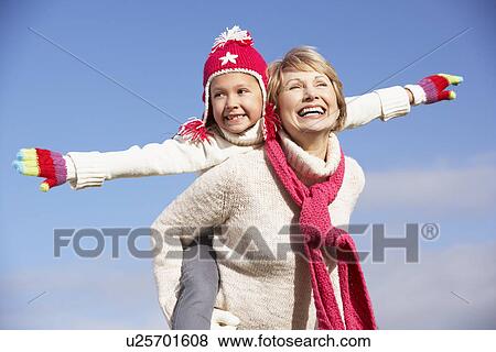 Stock Photo - Grandmother Giving Her Granddaughter A Piggy Back Ride. Fotosearch
