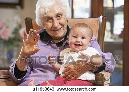 Grandmother holding her granddaughter on lap View Large Photo Image Stock Image - Grandmother holding her granddaughter on lap. Fotosearch
