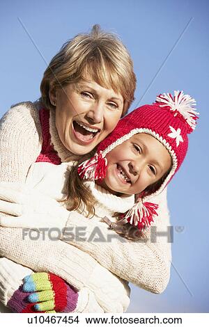 Grandmother Hugging Her Granddaughter View Large Photo Image Picture - Grandmother Hugging Her Granddaughter. Fotosearch