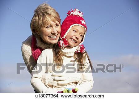 Picture - Grandmother Hugging Her Granddaughter. Fotosearch
