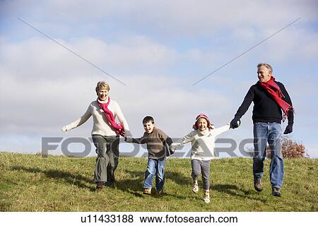 Stock Photo - Grandparents And Grandchildren Running In The Park. Fotosearch