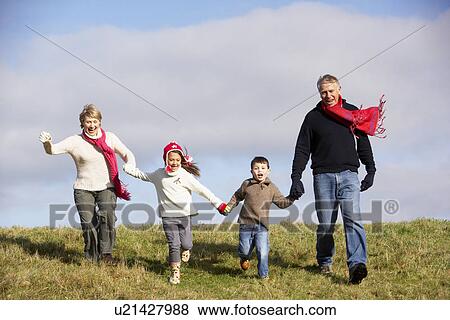 Stock Photo - Grandparents And Grandchildren Running In The Park. Fotosearch