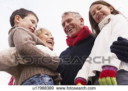 Stock Photo - Grandparents Hugging Their Grandchildren. Fotosearch