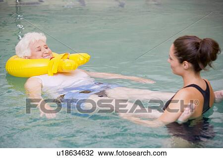Instructor And Elderly Patient Undergoing Water Therapy View Large Photo Image Stock Image - Instructor And Elderly Patient Undergoing Water Therapy. Fotosearch