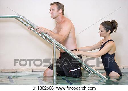 Instructor And Patient Undergoing Water Therapy View Large Photo Image Stock Photograph - Instructor And Patient Undergoing Water Therapy. Fotosearch