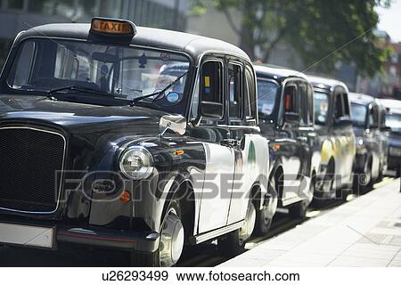 London Taxis Lined Up On Sidewalk View Large Photo Image Stock Photo - London Taxis Lined Up On Sidewalk. Fotosearch