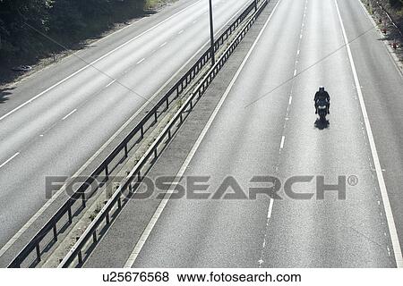 Lone Biker On An Empty Highway View Large Photo Image Stock Photo - Lone Biker On An Empty Highway. Fotosearch