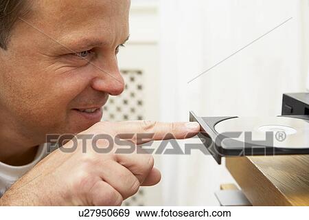 Man Closing DVD Player With Finger View Large Photo Image Stock Photo - Man Closing DVD Player With Finger. Fotosearch