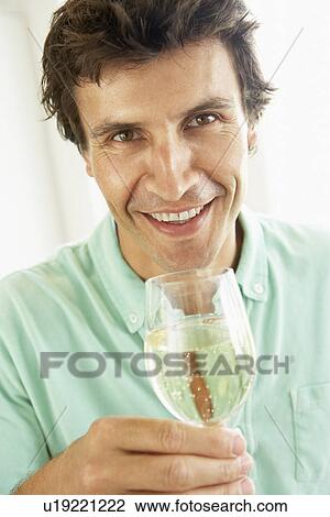 Stock Image - Man Drinking A Glass Of White Wine. Fotosearch