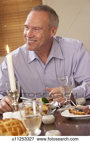 Stock Photo - Man Eating Dinner At Home. Fotosearch