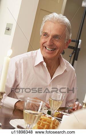 Stock Photo - Man Eating Dinner At Home. Fotosearch