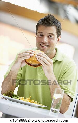 Man Eating Lunch At A Cafe View Large Photo Image Stock Image - Man Eating Lunch At A Cafe. Fotosearch