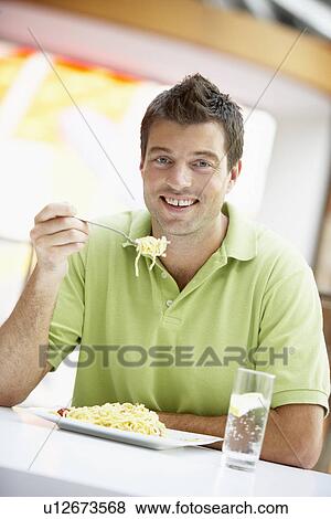 Stock Photo - Man Eating Lunch At A Cafe. Fotosearch