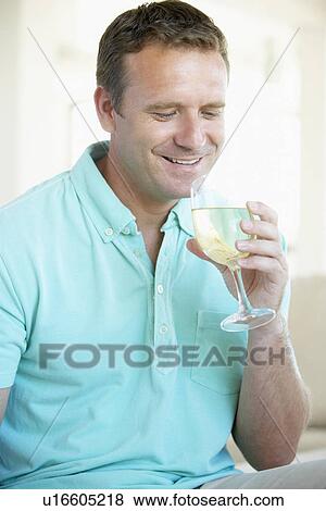 Man Enjoying A Glass Of White Wine View Large Photo Image Stock Photo - Man Enjoying A Glass Of White Wine. Fotosearch