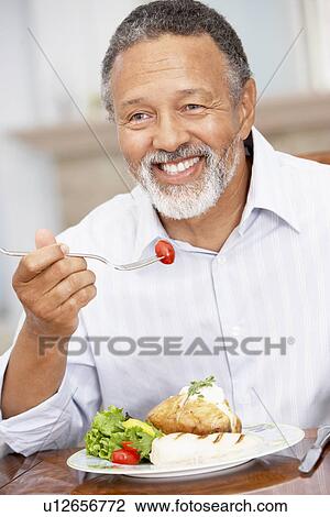 Man Enjoying A Meal At Home View Large Photo Image Stock Image - Man Enjoying A Meal At Home. Fotosearch