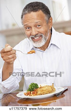 Man Enjoying A Meal At Home View Large Photo Image Stock Photo - Man Enjoying A Meal At Home. Fotosearch