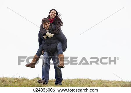 Man Giving His Wife Piggy Back Ride View Large Photo Image Stock Photography - Man Giving His Wife Piggy Back Ride. Fotosearch