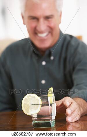 Man Having A Drink At Home View Large Photo Image Stock Photo - Man Having A Drink At Home. Fotosearch