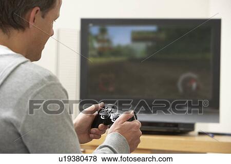 Stock Photo - Man Playing With Game Console. Fotosearch
