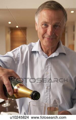 Man Pouring A Glass Of Champagne View Large Photo Image Picture - Man Pouring A Glass Of Champagne. Fotosearch