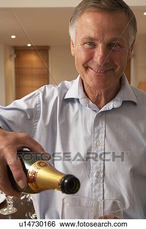 Man Pouring A Glass Of Champagne View Large Photo Image Stock Photograph - Man Pouring A Glass Of Champagne. Fotosearch
