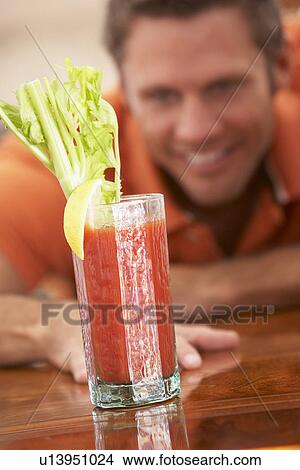 Picture - Man Reaching For A Bloody Mary. Fotosearch