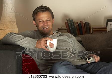 Man Relaxing With Coffee And Television View Large Photo Image Stock Image - Man Relaxing With Coffee And Television. Fotosearch