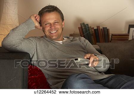 Man Relaxing With Remote Control View Large Photo Image Stock Image - Man Relaxing With Remote Control. Fotosearch