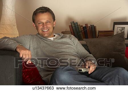 Man Relaxing With Remote Control View Large Photo Image Stock Image - Man Relaxing With Remote Control. Fotosearch