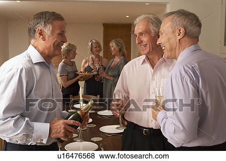 Man Serving Champagne To His Guests At A Dinner Party View Large Photo Image Stock Photo - Man Serving Champagne To His Guests At A Dinner Party. Fotosearch