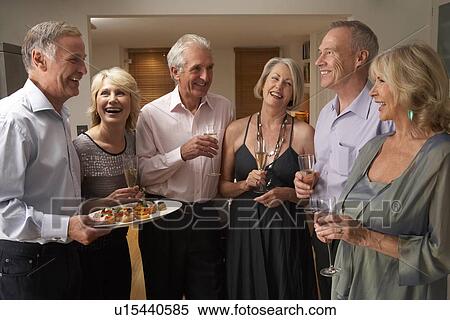 Man Serving Hors D'oeuvres To His Guests At A Dinner Party View Large Photo Image Stock Photography - Man Serving Hors D'oeuvres To His Guests At A Dinner Party. Fotosearch