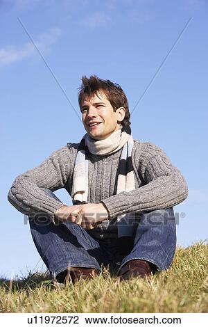 Stock Image - Man Sitting In Park. Fotosearch