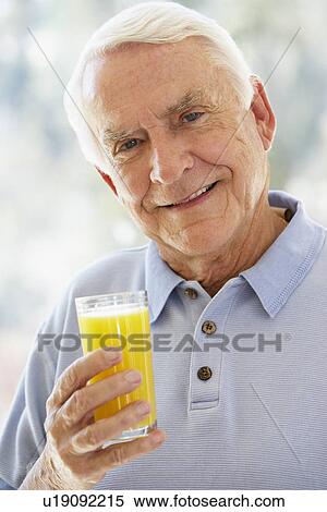Man Smiling At Camera And Drinking Orange Juice View Large Photo Image Stock Photography - Man Smiling At Camera And Drinking Orange Juice. Fotosearch