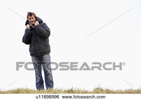 Stock Photograph - Man Standing In Park. Fotosearch