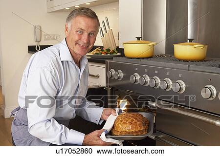 Man Taking Food Out Of The Oven View Large Photo Image Stock Image - Man Taking Food Out Of The Oven. Fotosearch