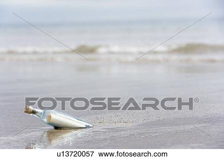 Message In A Bottle Buried In Sand On The Beach View Large Photo Image Stock Photo - Message In A Bottle Buried In Sand On The Beach. Fotosearch
