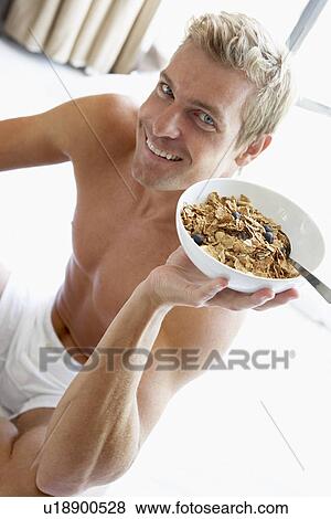Mid Adult Man Eating A Bowl Of Cereal View Large Photo Image Stock Photo - Mid Adult Man Eating A Bowl Of Cereal. Fotosearch
