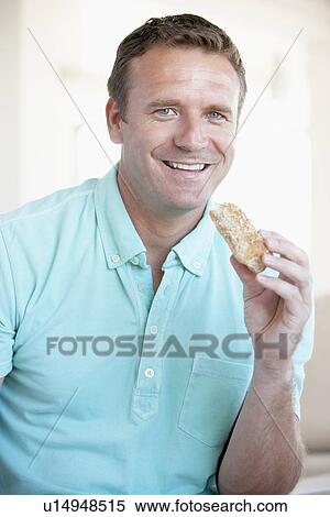 Mid Adult Man Eating Brown Bread Roll View Large Photo Image Stock Photography - Mid Adult Man Eating Brown Bread Roll. Fotosearch