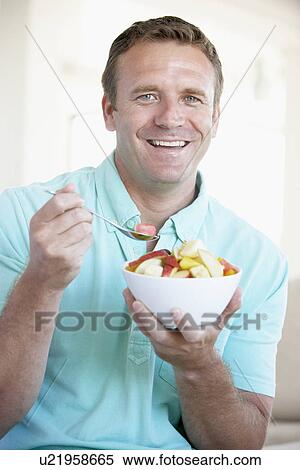 Mid Adult Man Eating Fresh Fruit Salad View Large Photo Image Stock Photography - Mid Adult Man Eating Fresh Fruit Salad. Fotosearch