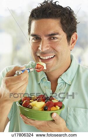 Mid Adult Man Holding A Bowl Of Fresh Fruit Salad Smiling At The Camera View Large Photo Image Picture - Mid Adult Man Holding A Bowl Of Fresh Fruit Salad Smiling At The Camera. Fotosearch