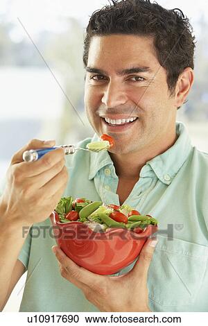 Mid Adult Man Holding A Bowl Of Salad, Smiling At The Camera View Large Photo Image Stock Image - Mid Adult Man Holding A Bowl Of Salad, Smiling At The Camera. Fotosearch
