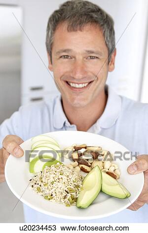 Mid Adult Man Holding Plate Of Healthy Food View Large Photo Image Stock Image - Mid Adult Man Holding Plate Of Healthy Food. Fotosearch