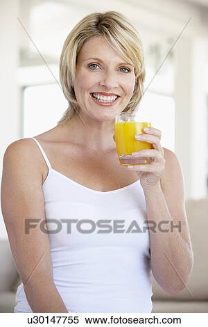 Mid Adult Woman Drinking Orange Juice View Large Photo Image Stock Photography - Mid Adult Woman Drinking Orange Juice. Fotosearch