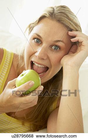 Mid Adult Woman Eating A Healthy Apple View Large Photo Image Stock Photo - Mid Adult Woman Eating A Healthy Apple. Fotosearch