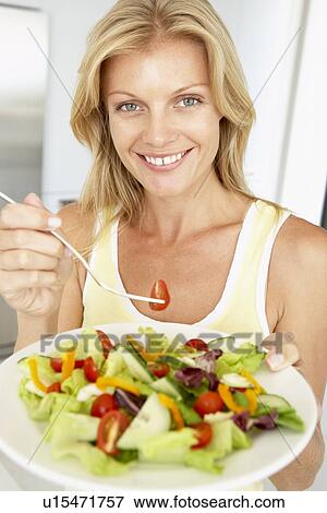 Mid Adult Woman Eating A Healthy Salad View Large Photo Image Stock Photo - Mid Adult Woman Eating A Healthy Salad. Fotosearch