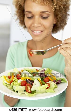 Mid Adult Woman Eating A Healthy Salad View Large Photo Image Stock Photo - Mid Adult Woman Eating A Healthy Salad. Fotosearch