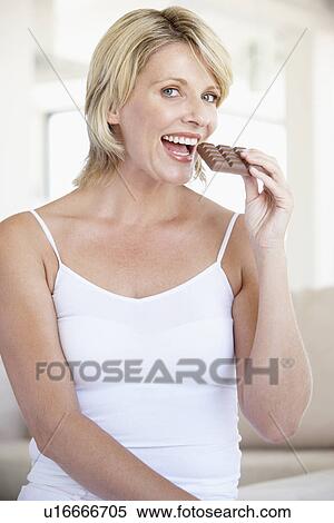 Mid Adult Woman Eating Chocolate View Large Photo Image Stock Photography - Mid Adult Woman Eating Chocolate. Fotosearch
